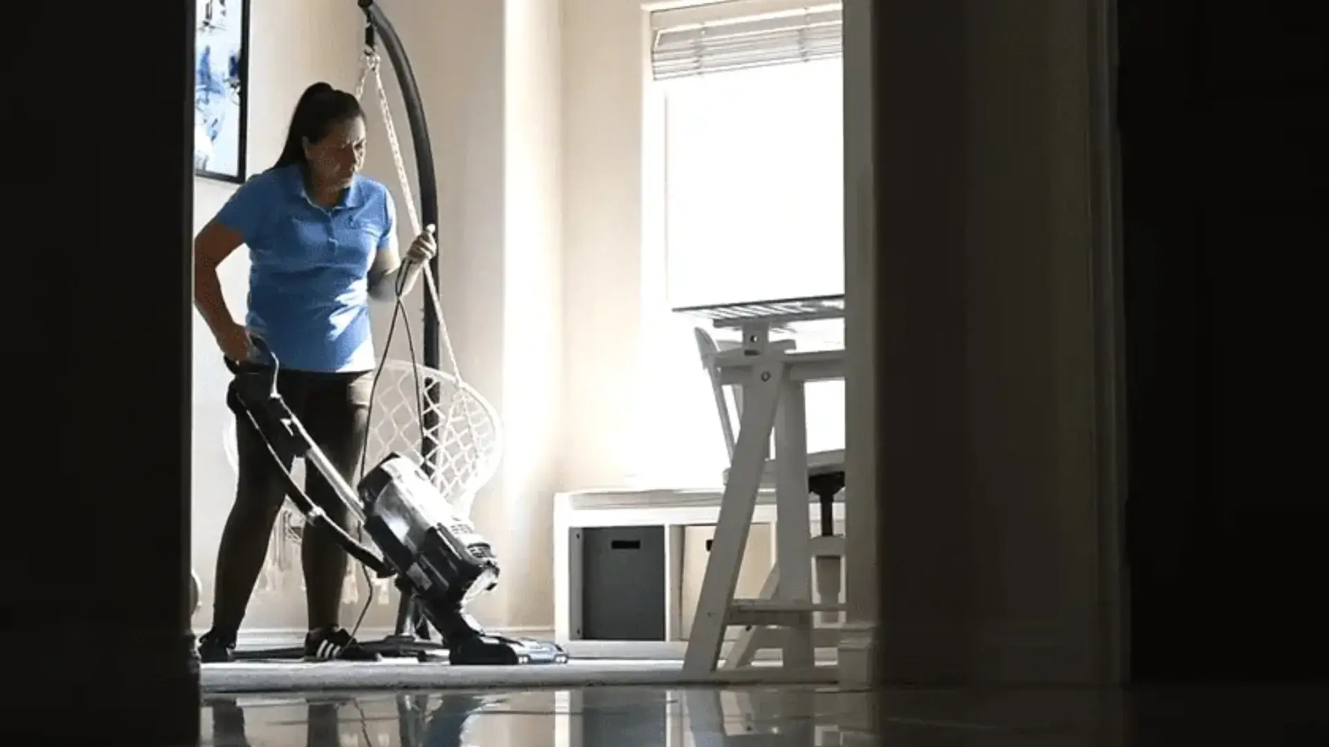 Cleaner vacuuming a room during moving cleaning services in Tri-Cities